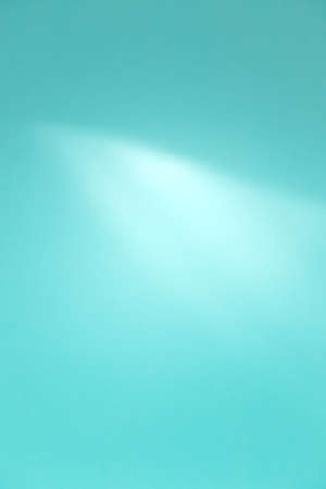 Blue abstract defocused background with bright light emphasis, vertical