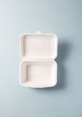 Paper plastic-free food container, vertical top view. Single-use dinnerware non-plastic alternatives concept. Minimalistic eco-friendly pack takeawayの写真素材
