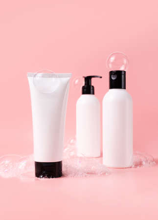 Beauty products set with soapy bubbles. Skin, body and hair care cosmetic bottles mockupの写真素材