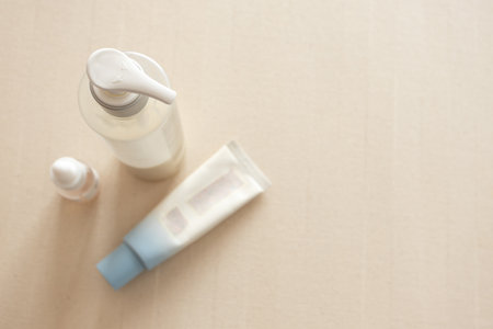 Skincare and cosmetic products on neutral beige background. Beauty, dermatology, personal care, wellness, and natural cosmetic branding conceptの写真素材