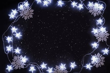 Illuminating stars and glitter snowflakes on the night sky.の写真素材