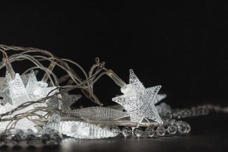 Illuminating crystalline stars and beads on the black background.の写真素材