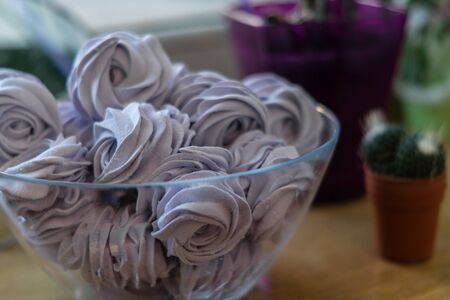 Violet marshmallow in form of rose in a large glass bowlの写真素材