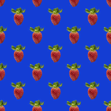 Seamless pattern with whole fresh beautiful red strawberries on solid bright blue background. Strawberries in rows.の写真素材
