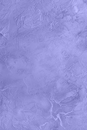 Close-up of rough handmade textured concrete surface toned in very peri, color of year 2022. Empty full frame background, large copy space. Vertical orientation.の写真素材