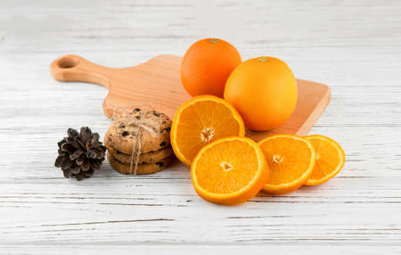 Homemade cookies and oranges on a white wooden table, top view.の写真素材