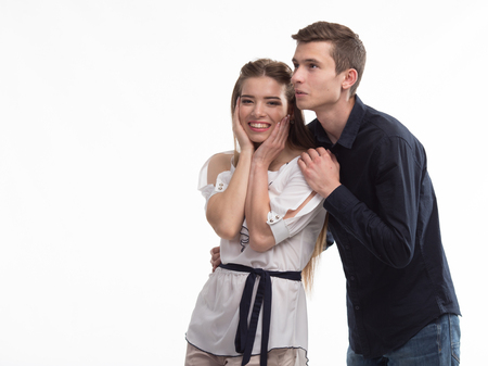 Young happy couple showing presentation pointing on placard overの写真素材