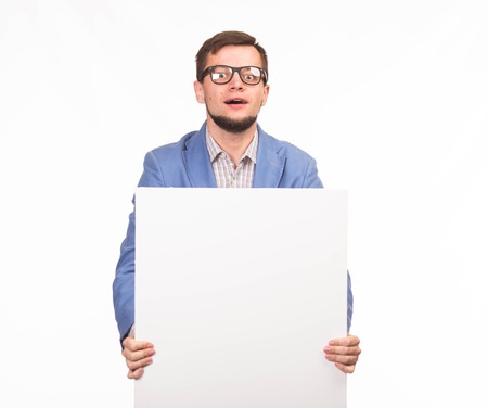 Young enlivened man portrait of a confident businessman showing presentation, pointing paper placard...
