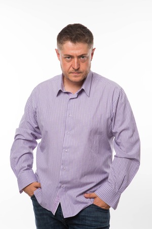 Young angry man portrait of a confident businessman showing by hands on a gray background. Ideal for banners, registration forms, presentation, landings, presenting concept.の写真素材