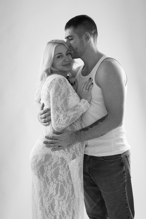 Beautiful pregnant couple in love on the background. Hands of husband on the tummy of his pregnant wife.の写真素材