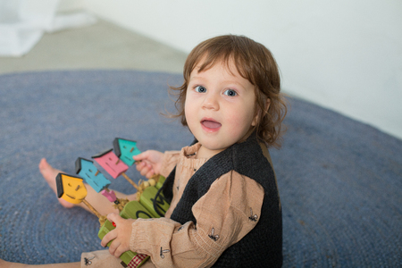 Little happy girl playing with toy on floor. Kindergarten.の写真素材