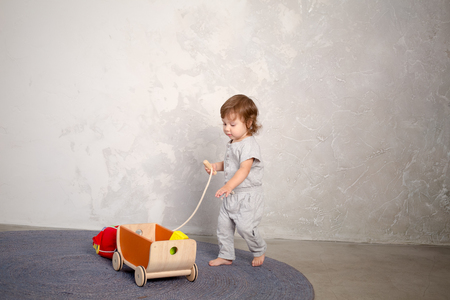 Little happy girl playing with toy on floor. Kindergarten.の写真素材