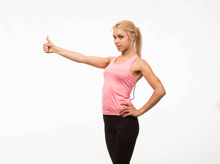 Young confident woman portrait of a confident businesswoman showing by hands on a gray background. Ideal for banners, registration forms, presentation, landings, presenting conceptの写真素材