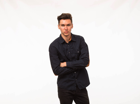 Young confident man portrait of a businessman on a gray background.の写真素材