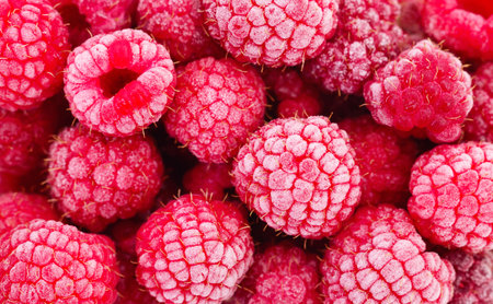 Frozen berries of raspberries, covered with hoarfrost as background.