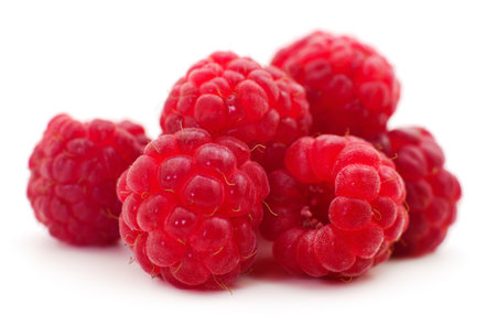 Group of raspberries on a white background.