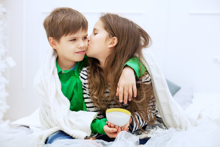 The little girl kisses and hugs boy. The concept of love and Valentine's Day.の写真素材