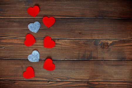Wooden background with red and gray hearts. The concept of love and Valentine's Day.の写真素材