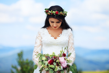 A young girl in a wreath in white dress. The concept of marriage and lifestyle.の写真素材