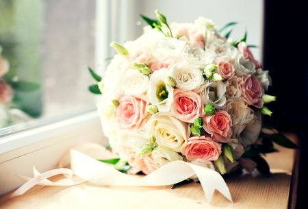 Beautiful wedding bouquet on the windowsill. The concept of marriage and love.の写真素材