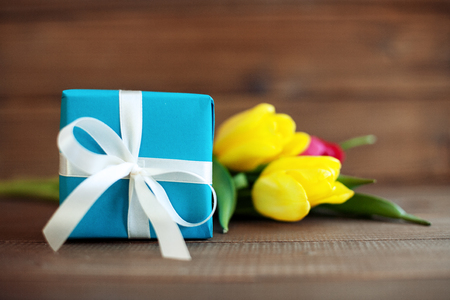 Blue gift with tulips. Conception holiday, March 8, birthday, Mother's Day.の写真素材