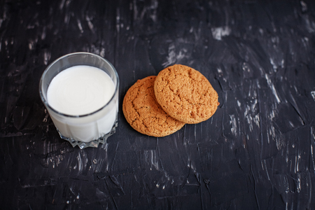 Oatmeal cookies and a glass of milk. Top view. The concept of healthy eating and vegetarianism.の写真素材
