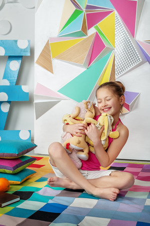 Child playing toys and hugs. The concept of childhood and play.の写真素材