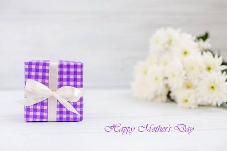 Purple box with a gift and flowers. The concept of Mother's Day.の写真素材