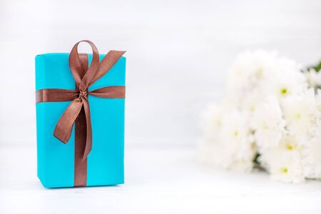 Box with a gift and flowers. The concept of Mother's Day, birthday, March 8.の写真素材
