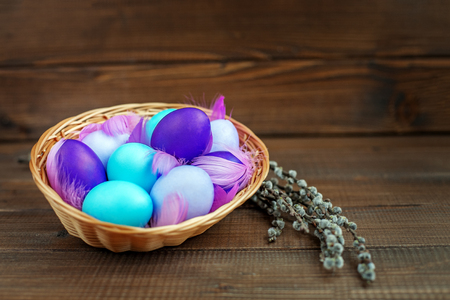 Eggs in a basket on a wooden background. Concept Happy Easter.の写真素材