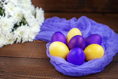 Flowers and eggs on a wooden background. Concept Happy Easter.の写真素材