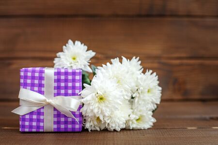 Gift and white flowers. The concept of Mother's Day, birthday, March 8.の写真素材