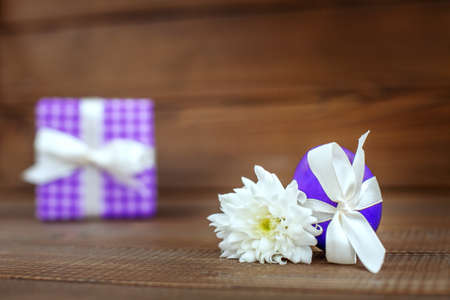 Egg and flower on a wooden background. Place for inscription. Concept Happy Easter.の写真素材