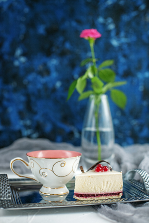 A cup of tea with lemon and pastries on a blue background. Breakfast. The concept of drinks and food.の写真素材