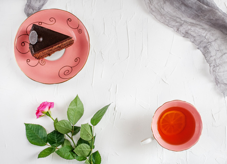 Chocolate cake and tea on a tray on bilomuu background. Top view. The concept of food, drink and desserts.の写真素材