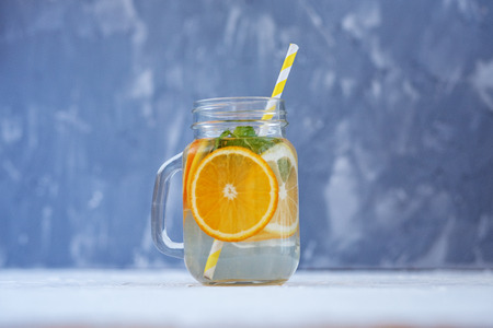 Detox water with lemon, orange and mint. Glass jar.The concept is summer, diet, vegetarian, fitness, healthy eating and lifestyle.の写真素材