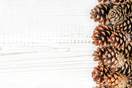 Wooden background with cones. Concept Happy Christmas, New Year, holiday, winter.の写真素材