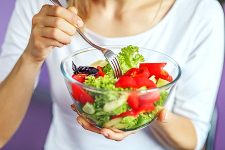Vegetable salad of tomatoes, cucumbers, basil and lettuce salad.の写真素材