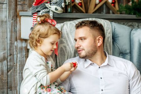 Young father with a little daughter. Concept of Merry Christmas, New Year, holiday, winter,...