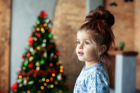 Little girl in pajamas. The concept of Christmas and New Year.の写真素材