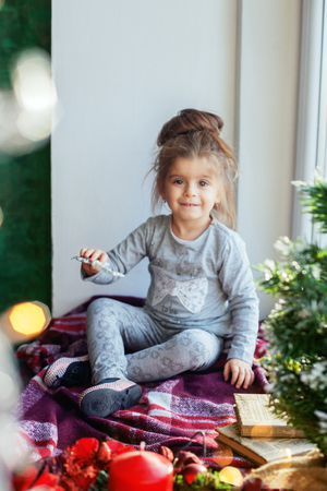 A child plays on the windowsill. The concept of Christmas.の写真素材