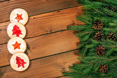 Wooden background with Christmas tree and cones. Delicious cookies. Top view. Concept of Happy Christmas, New Year, Winter, Holiday, Greetings, Food.の写真素材