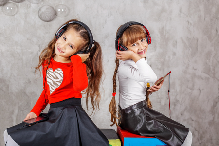 Two children in the headphones listen to music. Concept music, radio, dance, life stroke, rest.の写真素材