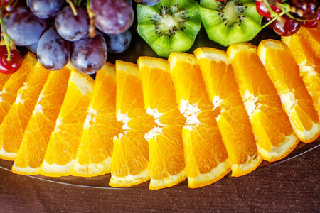 A set of fruits with oranges, kiwi, grapes and sweet cherries. The concept of healthy food and...