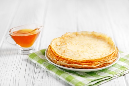 Delicious sweet pancakes with honey on the table. The concept of food, breakfast,  pancake week.の写真素材