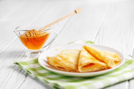 Pancakes with honey on the table. The concept of food, breakfast,  pancake week.の写真素材