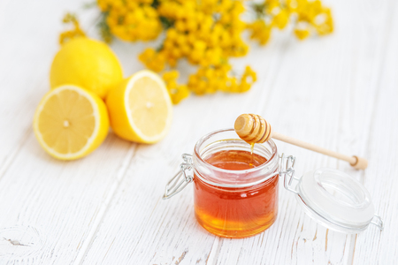 Useful honey and lemon. Honey dipper. The concept of healthy food, vegetarianism, autumn, colds,  treatment, cure, therapy, medication.の写真素材
