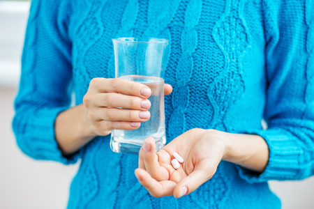 Tablets and water. Concept illness, colds, cure, fall and winter.の写真素材