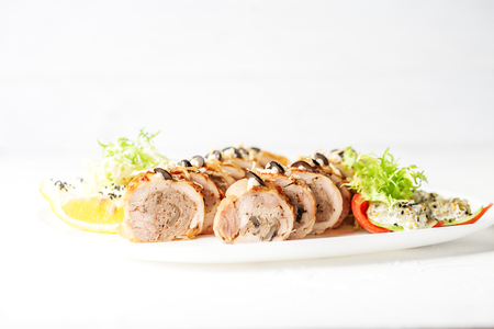 Baked chicken roll with mushrooms and tomatoes. The concept of nourishing food.の写真素材