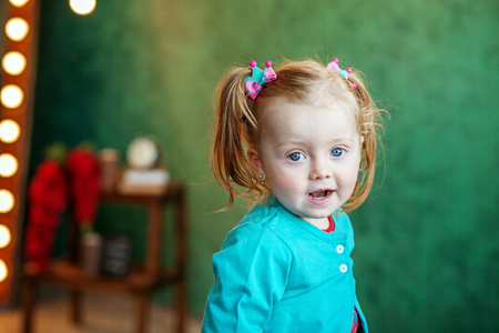 Cheerful little kid sitting in the room. 2-3 years. The concept of childhood and lifestyle.の写真素材